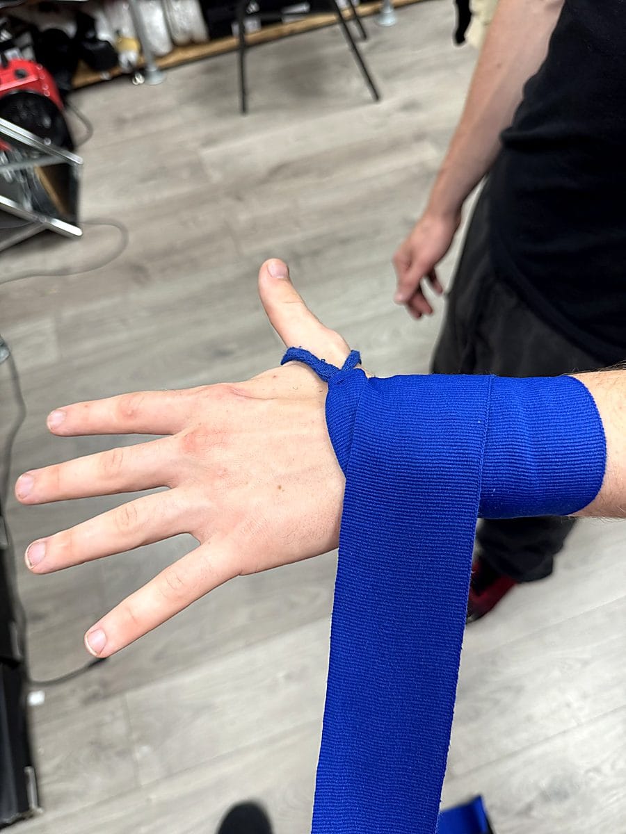 Step 2: Wrap the wrist three times with boxing hand wraps for joint support